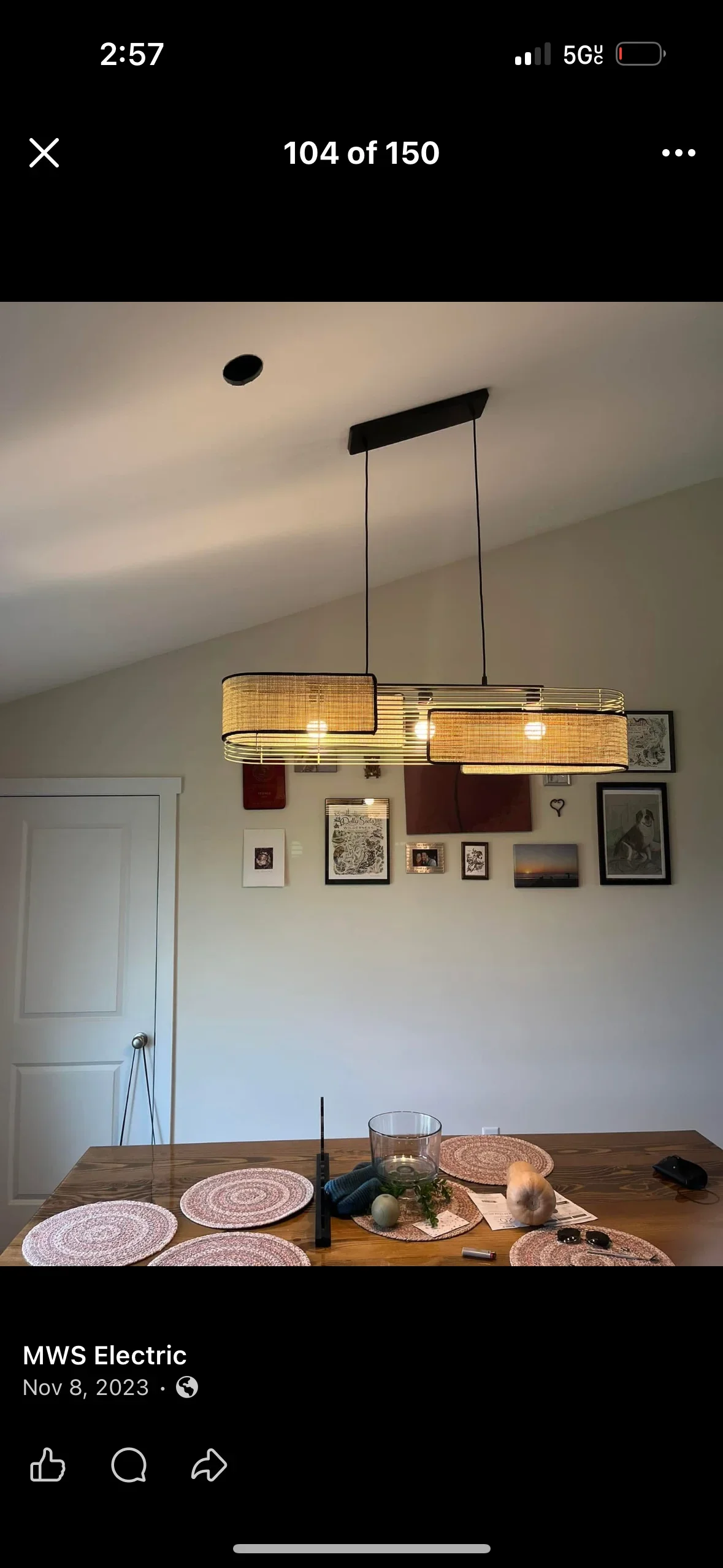 Dual rattan pendant light with black frame and LED bulbs installed above dining table